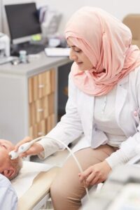 arab-female-doctor-examining-senior-patient_236854-21413
